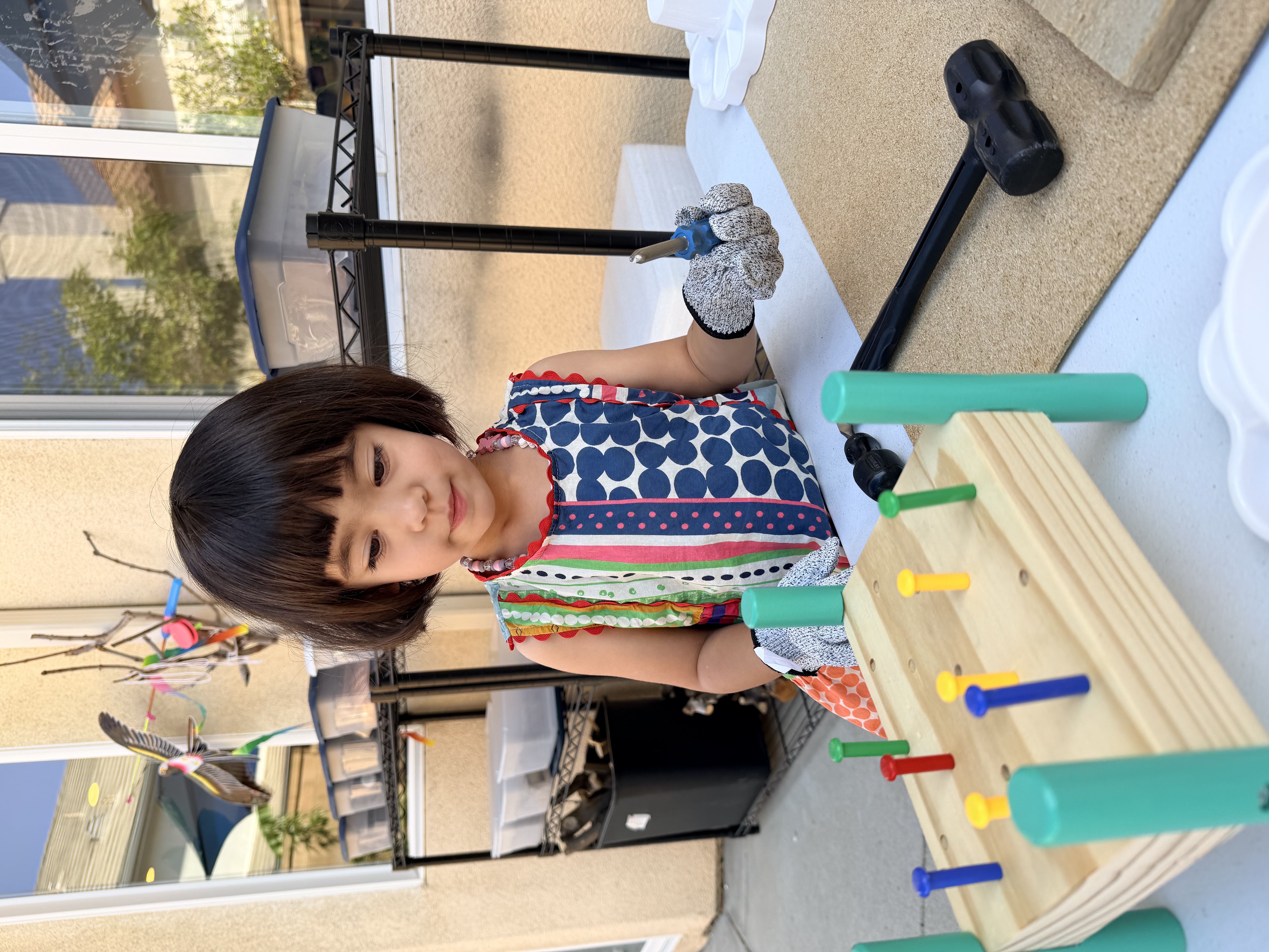 Children using loose parts and sensory materials outside